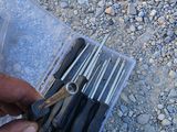 a person holding a bunch of tools in a plastic case
