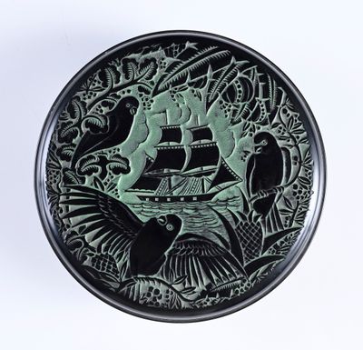 a black and green plate with an image of a ship on it