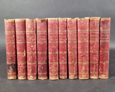 six old red books lined up in a row on a black surface
