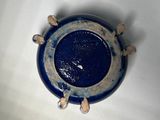 a blue and white plate on a white surface