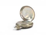 a silver pocket watch sitting on a white surface
