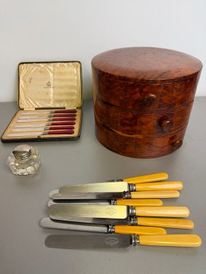 four knives and a box on the table