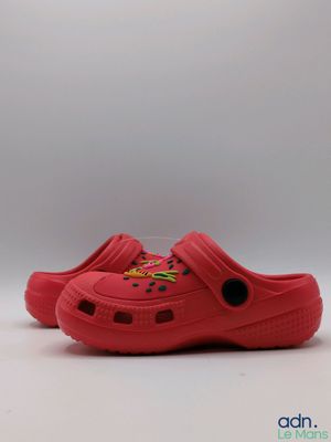 a close up of a pair of red shoes on a white surface