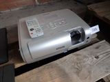 a projector sitting on top of a wooden table