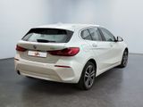 the rear end of a white bmw car in a white room