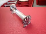 a small silver object on a red surface
