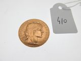 a close up of a gold coin with a price tag on it