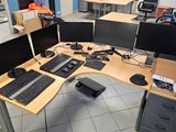 an image of a cubicle with multiple computers on it