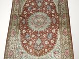 a red rug with a medallion design and fringes