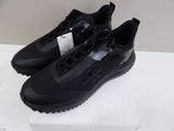 a pair of black sneakers on a white box on a table
