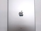 an apple ipad sitting on top of a table next to a white wall