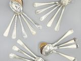 four silver spoons and two silver spoons on a table