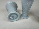 two vases sitting next to each other on a table