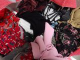 a pile of clothes in a bag on the floor