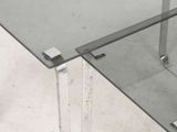 a glass table with a metal base and a glass top