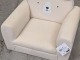 a white teddy bear chair sitting on the ground