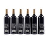 four bottles of wine are lined up on a white surface