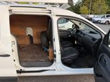a white van with the door open sitting in a parking lot