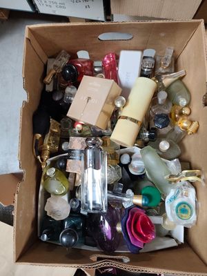 a cardboard box full of bottles and other items