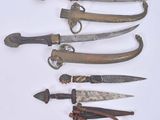 several different types of knives are displayed on a white surface