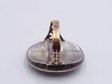 a silver spoon with a spoon in it on a white surface