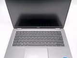 an open laptop computer sitting on top of a white table