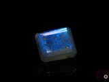 a close up of a square shaped blue stone on a black surface