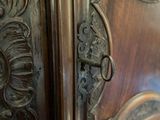 a close up of a wooden door with a metal handle