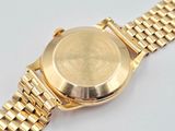 a close up of a gold watch on a white surface