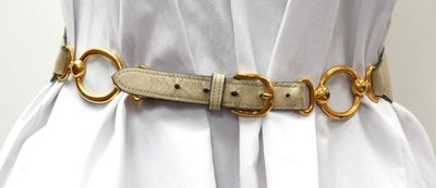 an image of a woman wearing a white dress and a gold belt