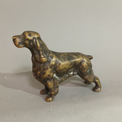 bronze dog figurine on a white background