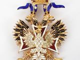 an image of a gold and blue badge with a crown on it