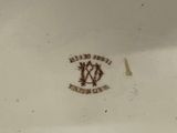 a white plate with a brown design on it