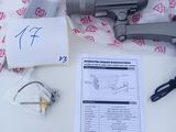 a gun that is sitting on a table next to a box