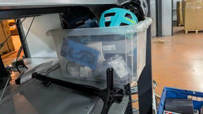 a plastic container with a helmet on it sitting on a shelf