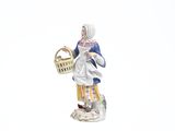 a figurine of a woman holding a basket