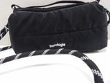 a black and white bag with a black strap on it