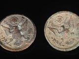 two ancient coins with an image of a man and a woman on them