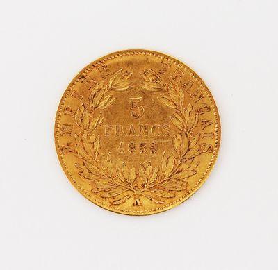a close up of a gold coin on a white surface
