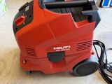 an image of a red vacuum cleaner sitting on top of a floor