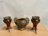 three vases that are sitting on a wooden table