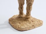 sculpture of a man and a woman standing on a rock