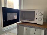 a microwave sitting on top of a counter next to a window