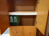 an open cabinet with a bunch of files on it