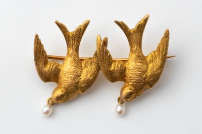 pair of gold bird brooches with pearls on white background