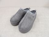 grey sued slippers with zippers on top of them on a white surface