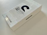 a white box on a table with a black logo on it