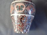 a vase with a decorative design on it on a table