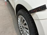 a white car with a ruler on the side of it