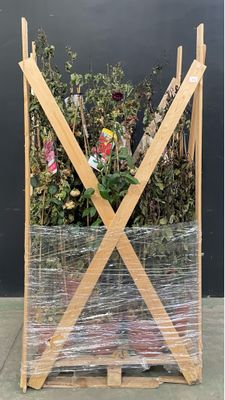 a plant that is wrapped in plastic on a pallet